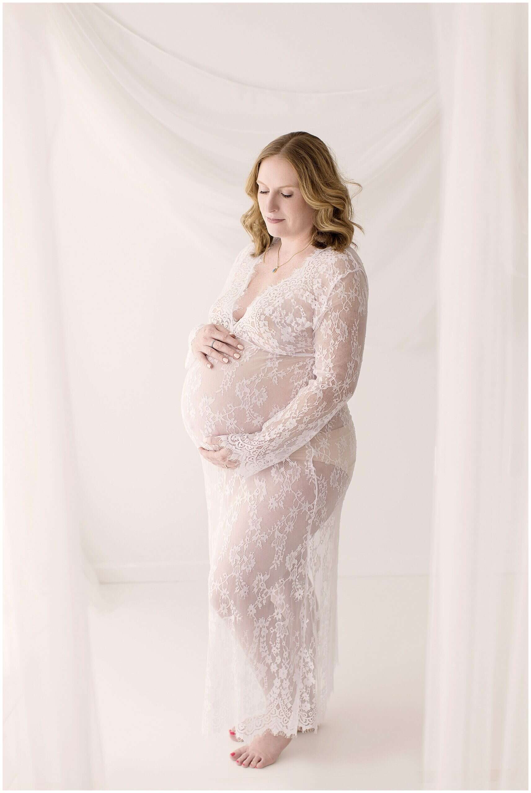 Expecting mother getting professional hair and makeup done during Cleveland studio maternity photo session