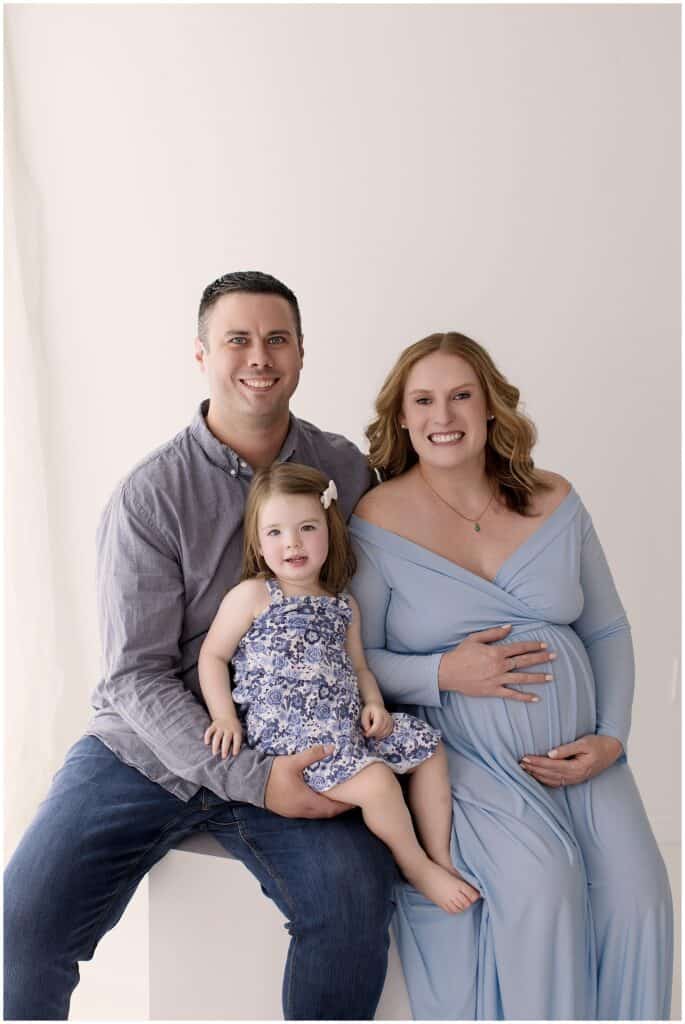 Beautiful Cleveland family maternity portrait with expecting parents and toddler daughter in studio