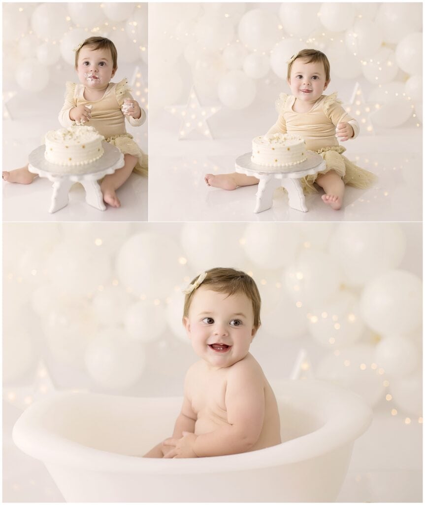 Baby girl laughing while eating cake with white balloon backdrop at Mary Christine Photography studio.