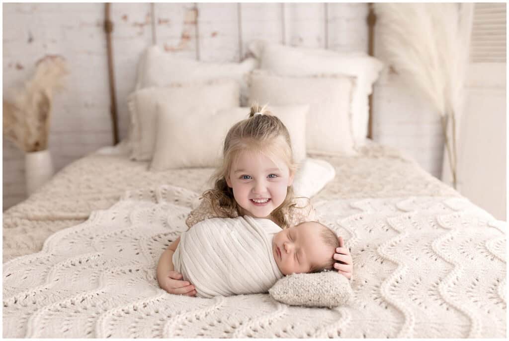 Newborn baby wrapped in neutral tones during a studio session with Northeast Ohio baby photographer Mary Christine.