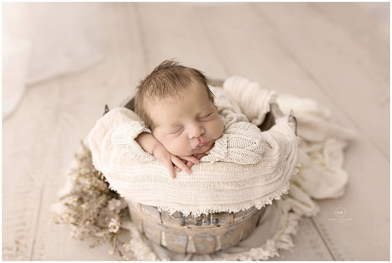 Newborn photography studio setup with wraps and props provided for the session