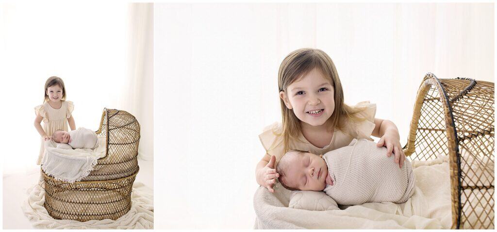 sibling newborn photography in Cleveland Ohio with big sister holding baby brother