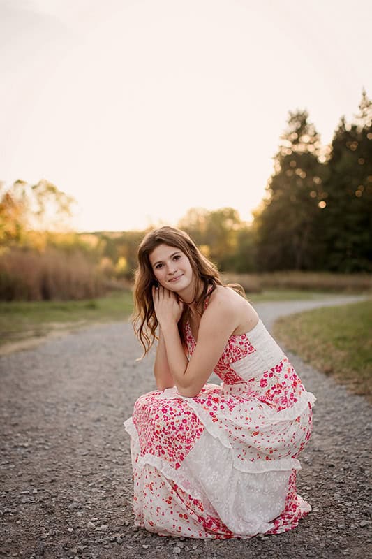 High school senior being guided through natural posing during a senior photo session in Medina, Ohio