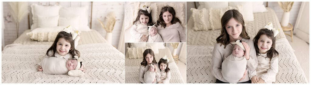 Big sister holding newborn baby girl during studio session in Medina Ohio