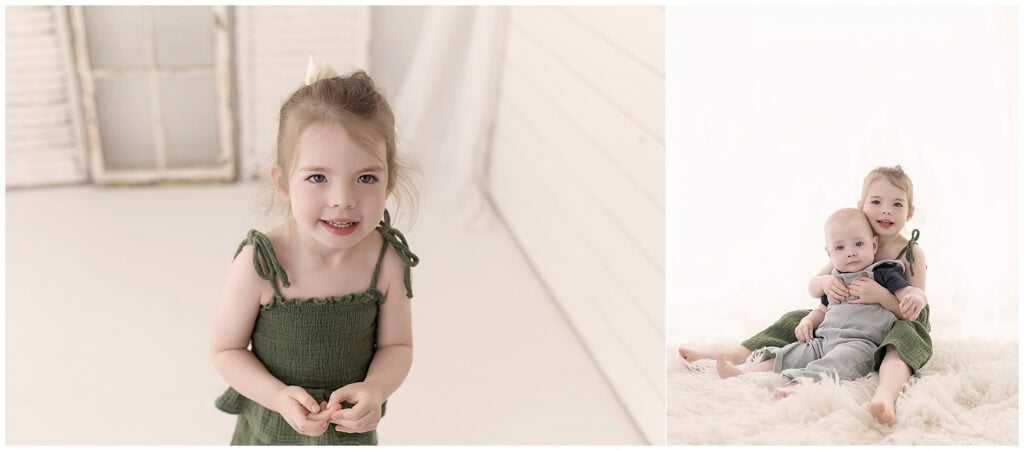 Big sister hugging her baby brother during a light and airy studio milestone session
