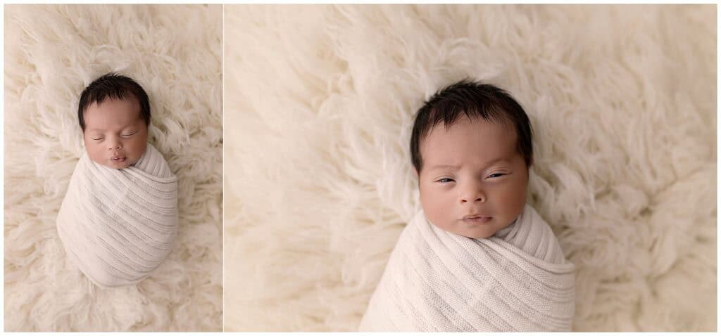 Wrapped newborn baby boy on soft cream flokati during studio newborn session